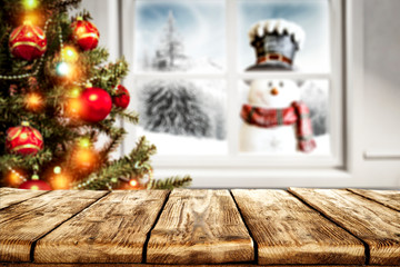 Desk of free space for your decoration and winter window background with snowman 