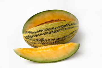Striped yellow with green stripes an oblong melon with a carved slice on a white background.