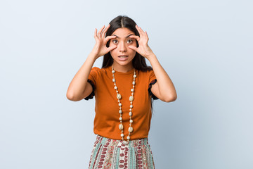 Young arab woman keeping eyes opened to find a success opportunity.