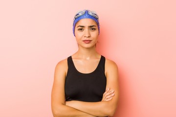 Young arab swimmer woman isolated unhappy looking in camera with sarcastic expression.