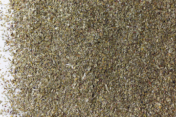 Background of green, natural, healthy mate tea scattered on the table.