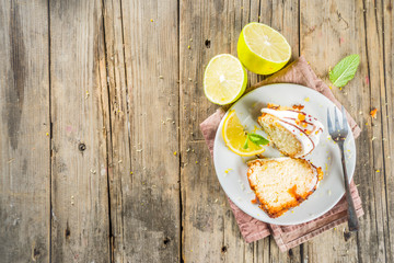 Homemade lemon bundt cake with sugar icing, fresh lemons and mint leaves, copy space