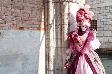 Fototapeta na wymiar A female carnival mask in piazza san marco in venice, near the Bridge of sighs. Italy