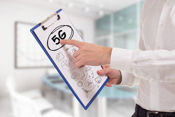 Business, technology, internet and network concept. Young businessman points to the keyword: 5G