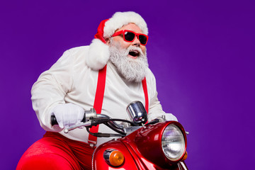 Photo of santa claus role man riding newyear x-mas theme party by bike excited to see friends wear...