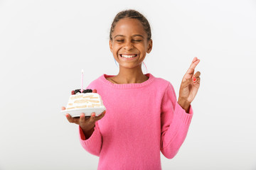 Image of excited african american girl holding piece of torte