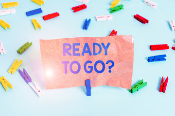 Text sign showing Ready To Go Question. Business photo text asking someone if he is prepared or packed his things Colored clothespin papers empty reminder blue floor background office pin