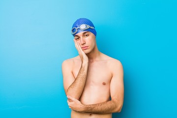 Fototapeta na wymiar Young swimmer man who is bored, fatigued and need a relax day.