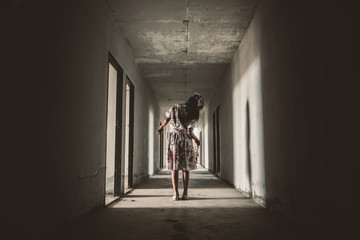 Ghost nurse woman or zombie holding the knife with resentment and malice in the building abandoned hospital.