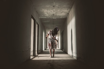 Ghost nurse woman or zombie holding the knife with resentment and malice in the building abandoned...