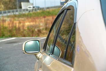 Photo of the darkened glass on the gold car