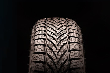 new directional friction winter tire Velcro without spikes on black background. rubber for ice...
