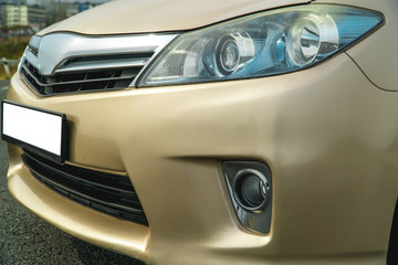 Photo of the front of the car in gold