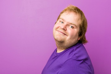 Fototapeta premium Young authentic redhead fat man relaxed and happy laughing, neck stretched showing teeth.