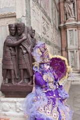 Fototapeta na wymiar Female carnival mask in Piazza San Marco in Venice during the carnival. Italy
