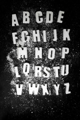 English alphabet. letters made of concrete on a black background.