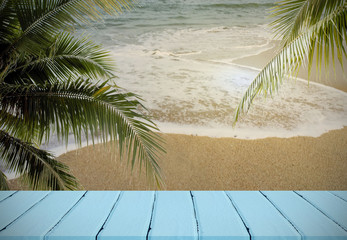 coconut tree on beach with Empty wooden table for background