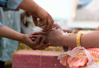 Pour water into the hand. Thai wedding ceremony is to tell the general public that they will live together. Promise to live together with men and women. Creating a shared future for two people.