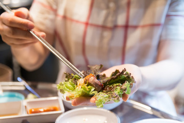 Korean BBQ, meat wrapped in lettuce