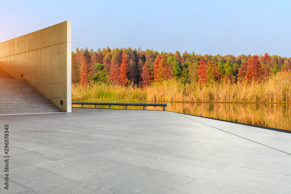 Wall mural Empty square floor and beautiful colorful forest in autumn