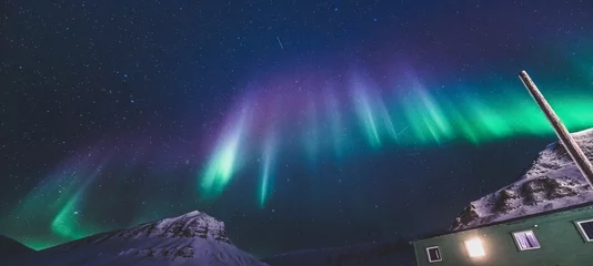 Fotobehang The polar arctic Northern lights hunting aurora borealis sky star in Norway travel photographer  Svalbard in Longyearbyen city the moon mountains © bublik_polina