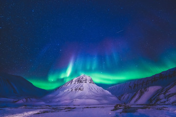 The polar arctic Northern lights hunting aurora borealis sky star in Norway travel photographer  Svalbard in Longyearbyen city the moon mountains - obrazy, fototapety, plakaty