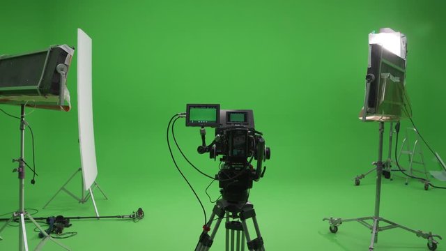 Behind The Scenes filming set red camera on tripod and green screen