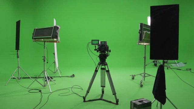 Behind The Scenes filming set red camera on tripod and green screen