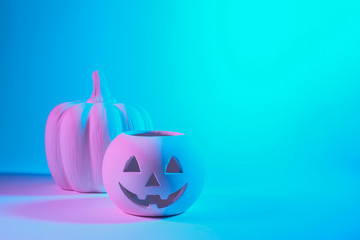 A Jack O Lantern glowing with neon light on Halloween evening. Pastel colors