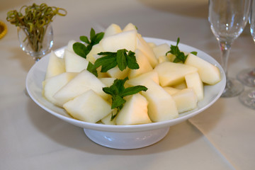 Melon sliced on a platter. Fruit on the holiday table.