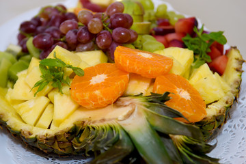 Salad of fruits and berries on a platter. Vitamins on the holiday table.