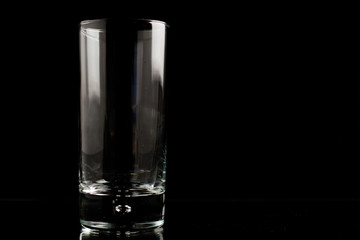 A glass of beer in a black scene