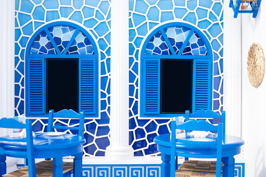 Greece style restaurant. Greek style decoration in blue and white. Inside the window is black screen that can insert photo , text or your personalized content.