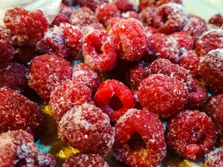 Frozen raspberry. Close up. Frozen raspberries on wooden tables.