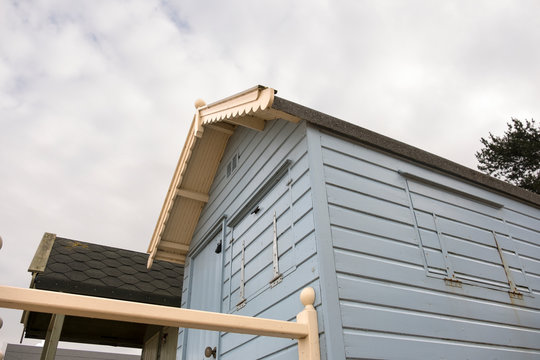 Blue beach hut with overcast sky background