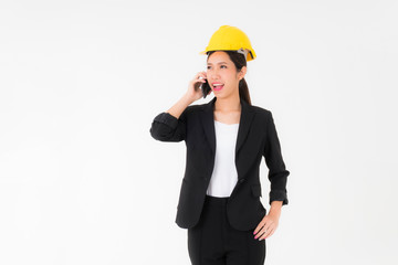 Portrait smiling Asian young engineer woman wearing a black suit black long hair and Yellow Safety helmet standing  with mobile phone copy space isolated on white background studio