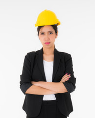 Asian young female engineers wearing a black suit and Yellow Safety helmet standing with crossed...
