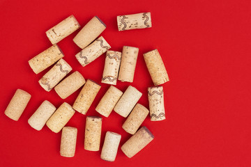 Minimal trendy concept with corks from wine bottles on red paper background with copy space. Flat lay for wine bar, winery, restaurant, wine list.