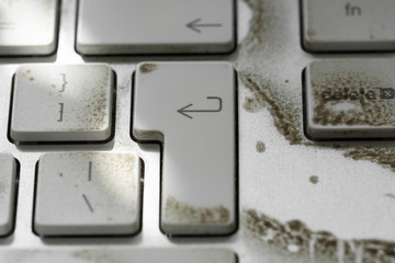 Close-up of a very dirty desktop keyboard from a well-known, computer and smartphone vendor.Showing...