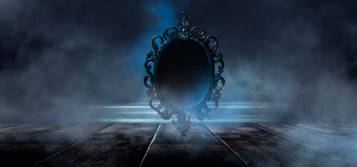 Dark night magic scene. Magic old mirror in a metal frame on a wooden tabletop. Smoke, magic,...