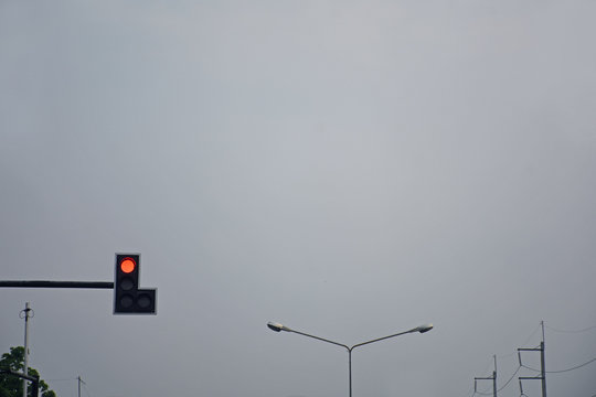 Traffic light at intersection roads show red light in twilight time.