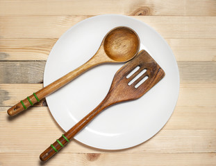 wooden spoon and paddle on light table background