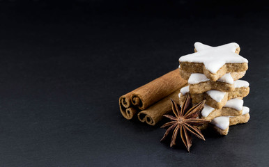 star shaped cinnamon cookies with cinnamon sticks and star anise 