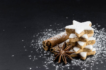 Fototapeta na wymiar star shaped cinnamon cookies with cinnamon sticks and star anise 