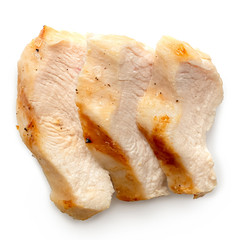 Three slices of grilled chicken breast with grill marks isolated on white. Top view.