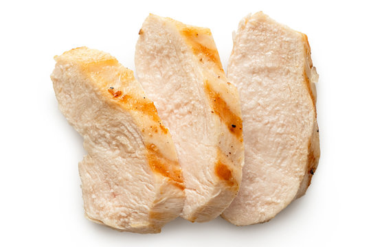 Three slices of grilled chicken breast with grill marks isolated on white. Top view.