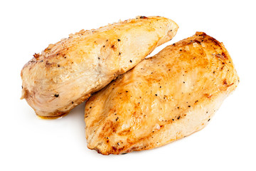 Two whole pan roasted chicken breasts isolated on white.