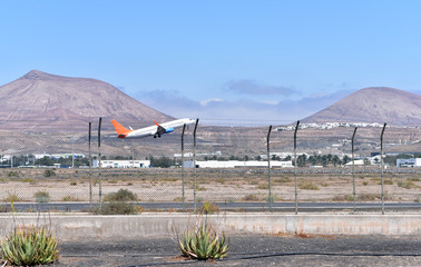 Passenger plane flying goes on takeoff in the blue sky, Lanzarote, Canary Islands, Spain