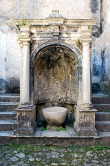 Ancient fountain in the courtyard of the charterhouse of Padula, Salerno, Italy