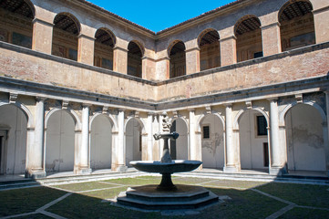 One of the cloisters of Padula Charterhouse with Padula hamlet in the background, Salerno, Italy © Tony